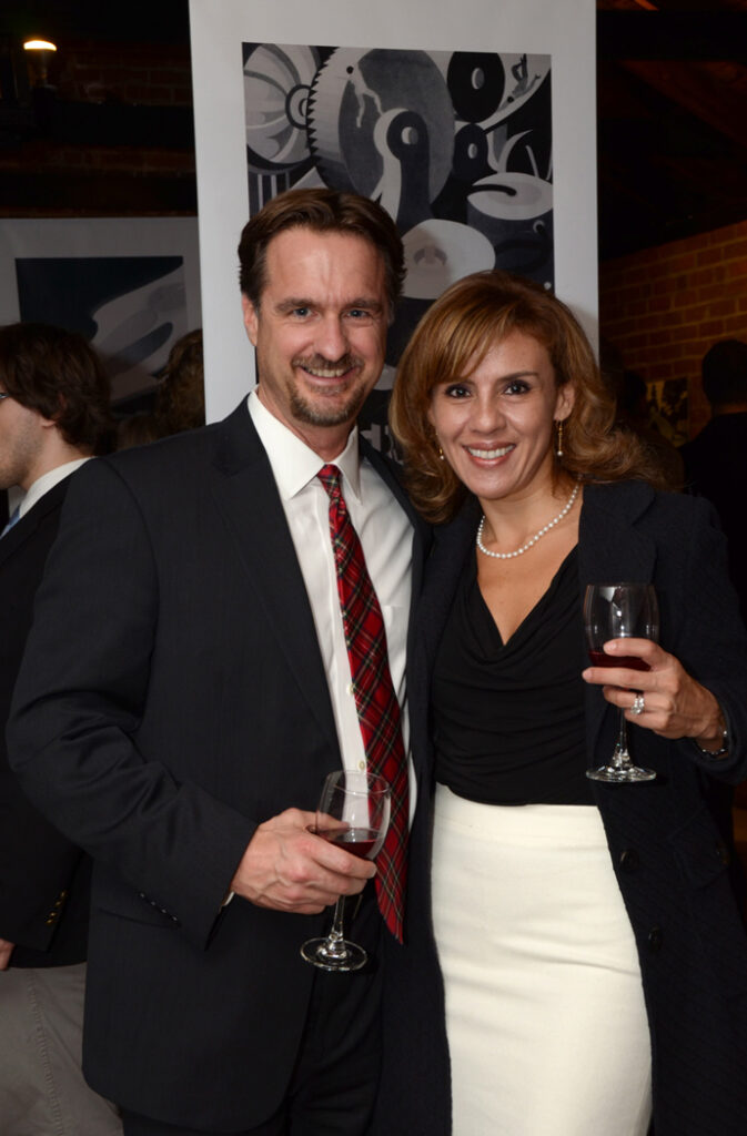 A well-dressed man and his wife posing for a photo